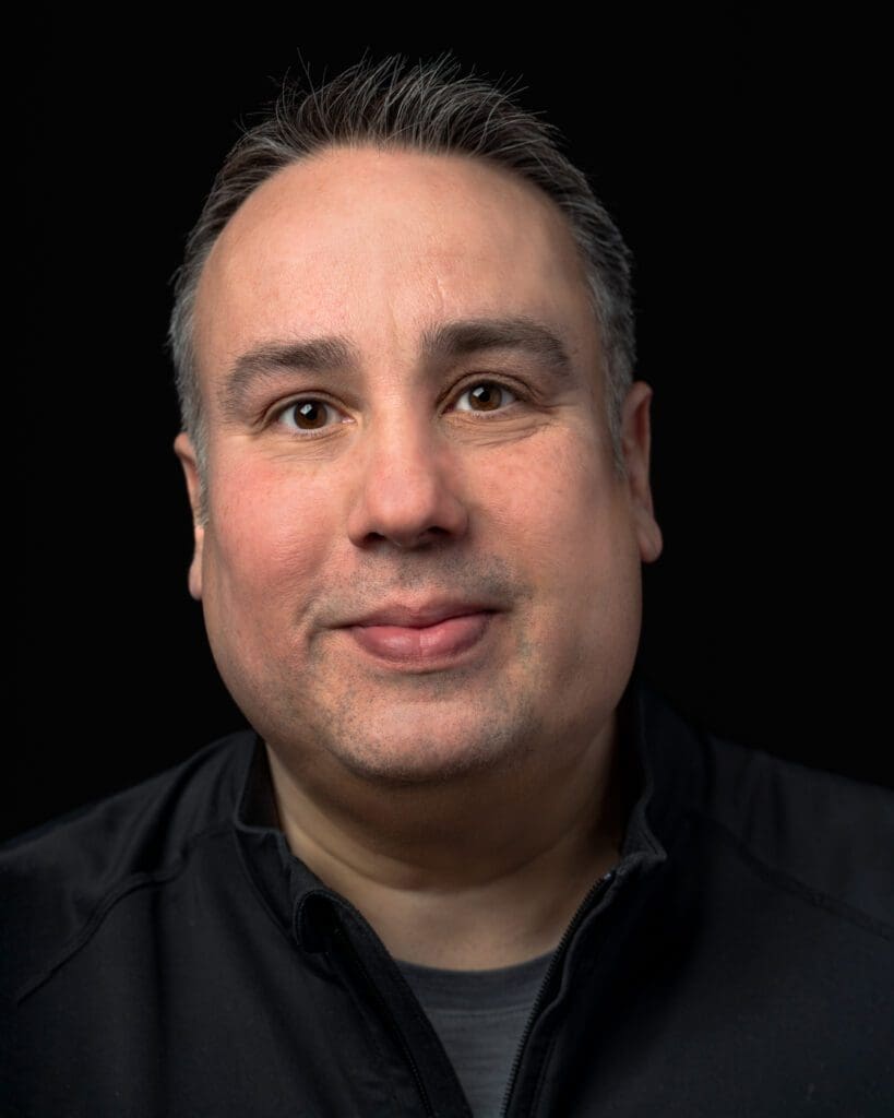 Headshot of a business person on a black background
